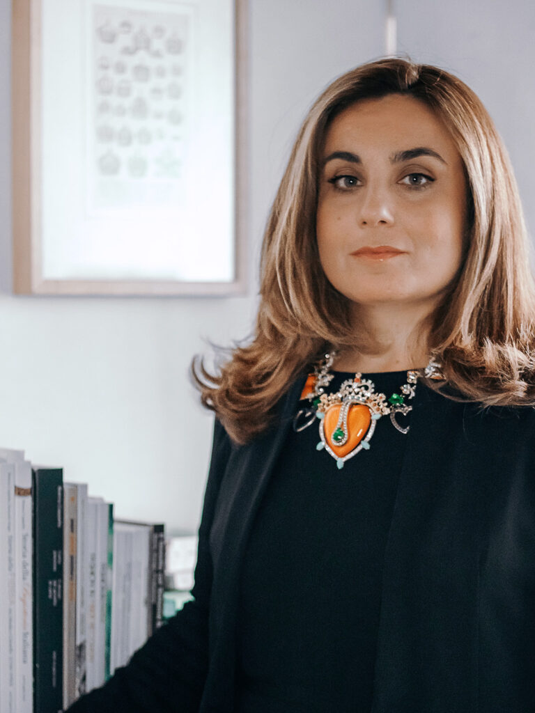 Bianca Cappello in her studio wearing a coral, emerald and diamond collar, portrait by Sogand Nobahar