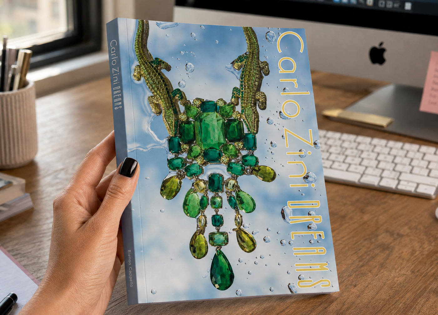 The Carlo Zini DREAMS book held in one hand, art direction, design and photography by Sogand Nobahar