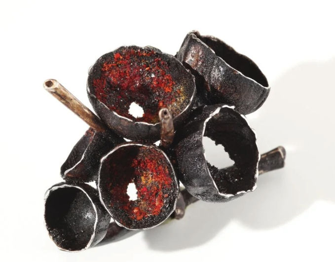 Reference photograph of a hand-made ClaraDelPapa art jewellery piece in blackened metal with red interior