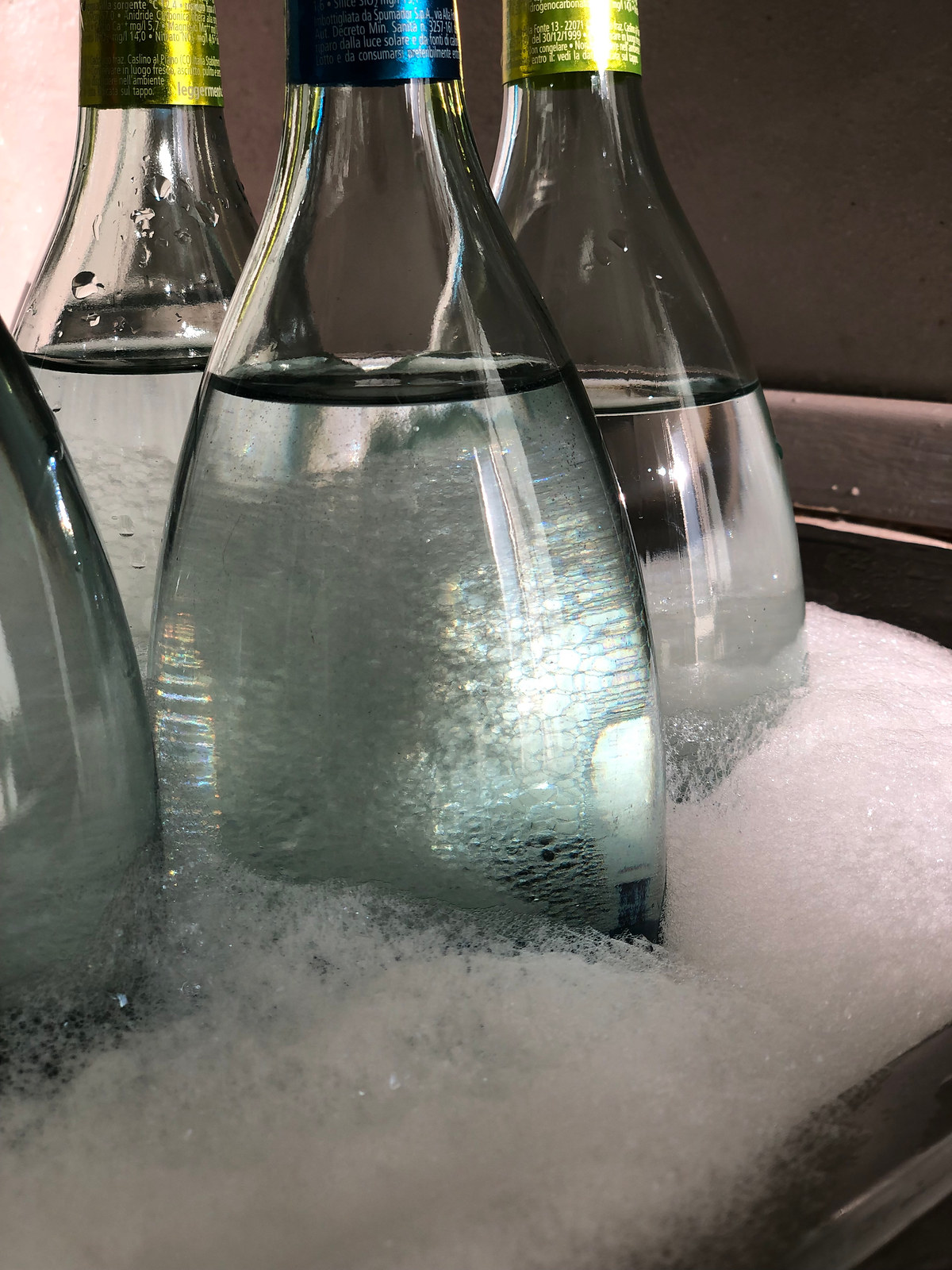Recovered bottles being washed in soapy water before cutting, exhibition display process by Sogand Nobahar