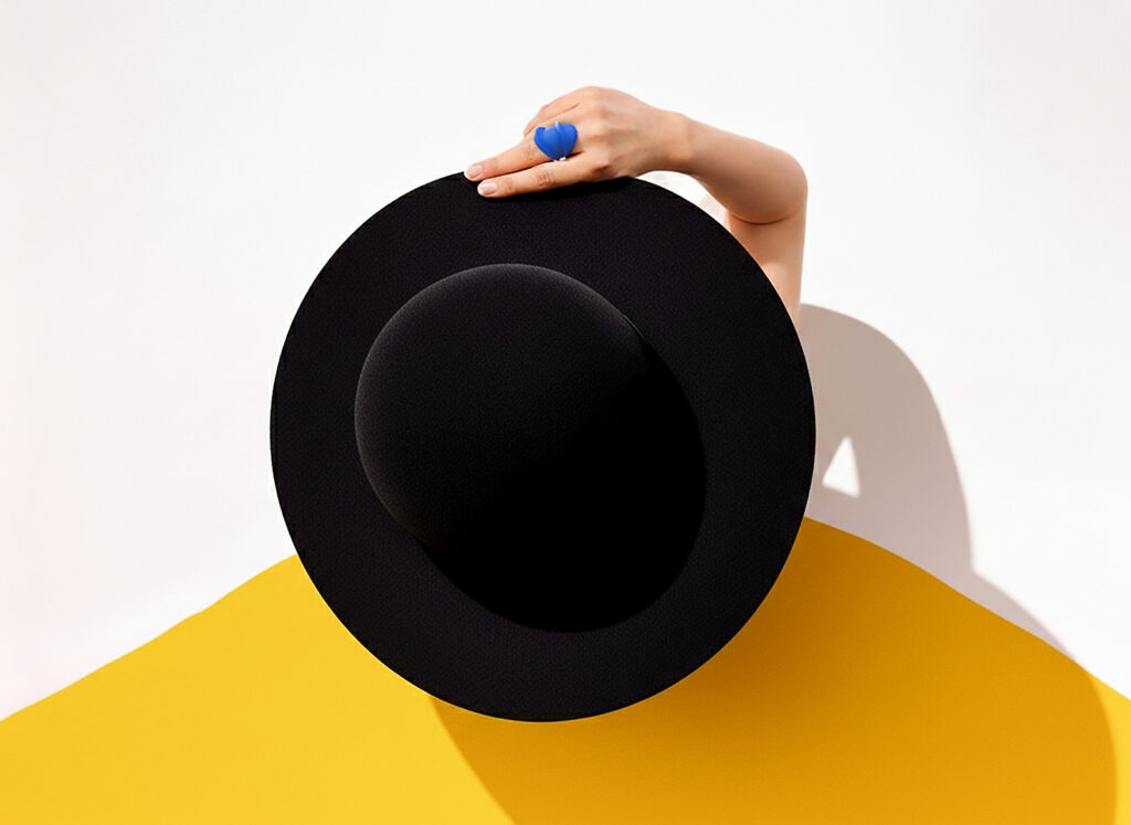Blue ring and black hat photographed overhead on a yellow ground, My City Tehran series by Nobahar Design