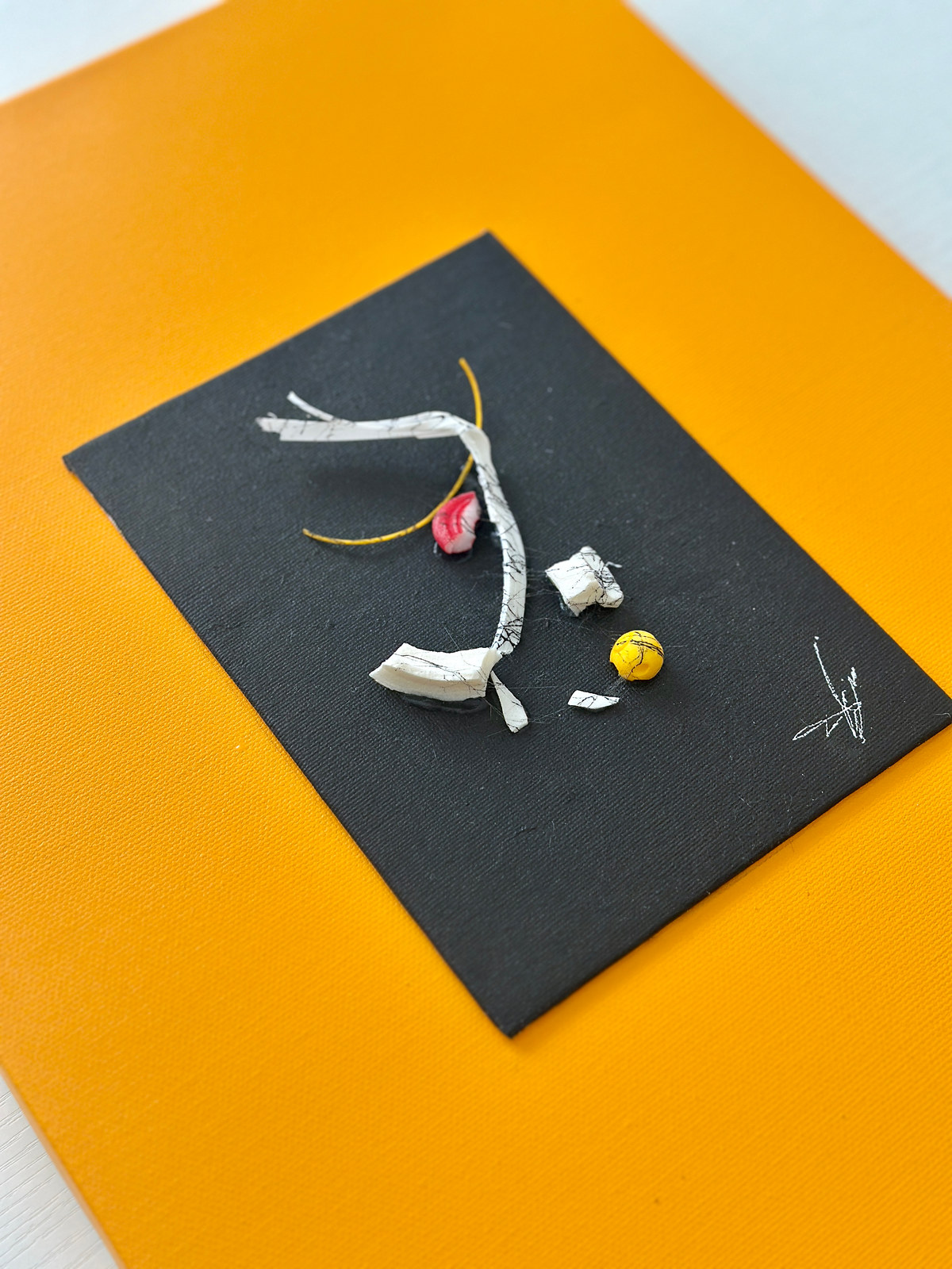 Persistenza piece 14, recomposed fragments on a black panel mounted on orange canvas, one-of-a-kind work by Sogand Nobahar