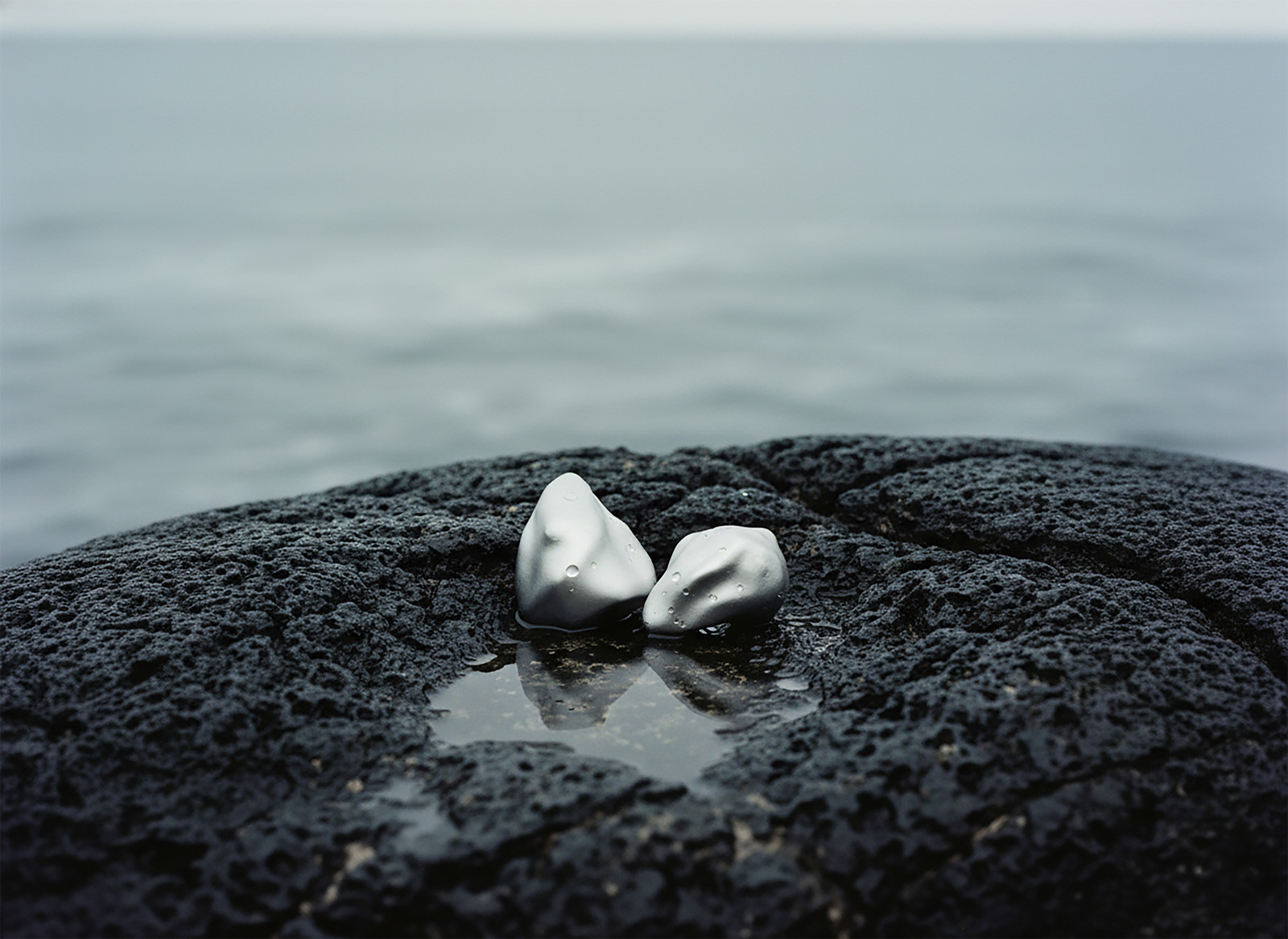 NEX Petroline earrings on volcanic rock, CGI campaign image, 3D modelling and rendering by Sogand Nobahar through Orbyline